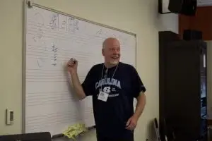 Dan Davis notates jazz chords, quizzing the students, during the basic music skills class. (Photo credit Cat Zachary)